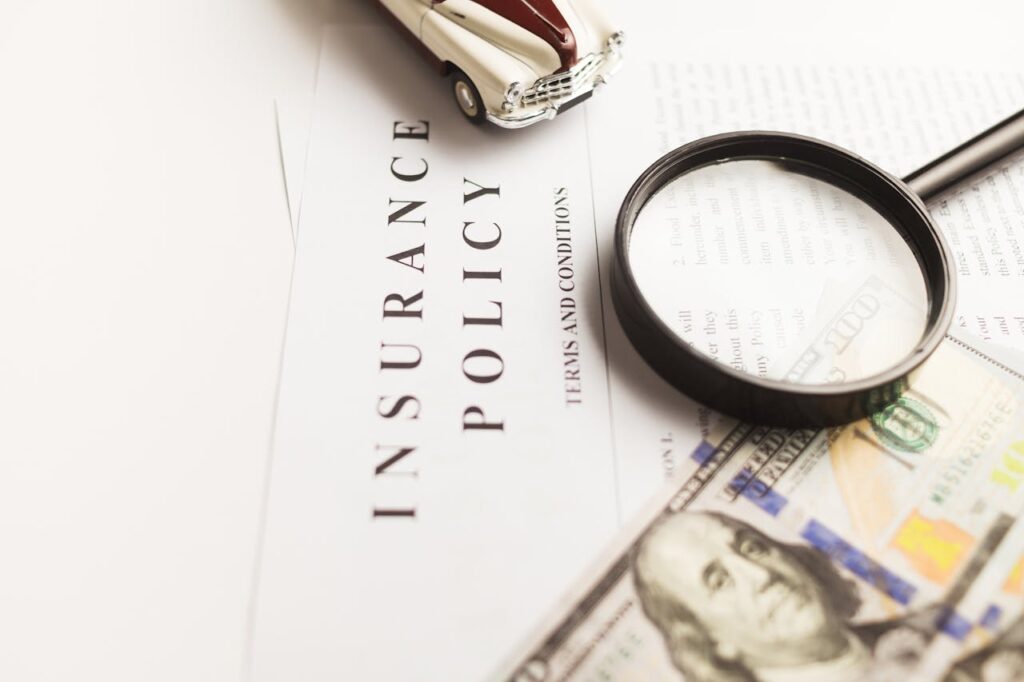 Mastering the First Impression: Your intriguing post title goes here Close-up image of an insurance policy with a magnifying glass, money, and toy car.